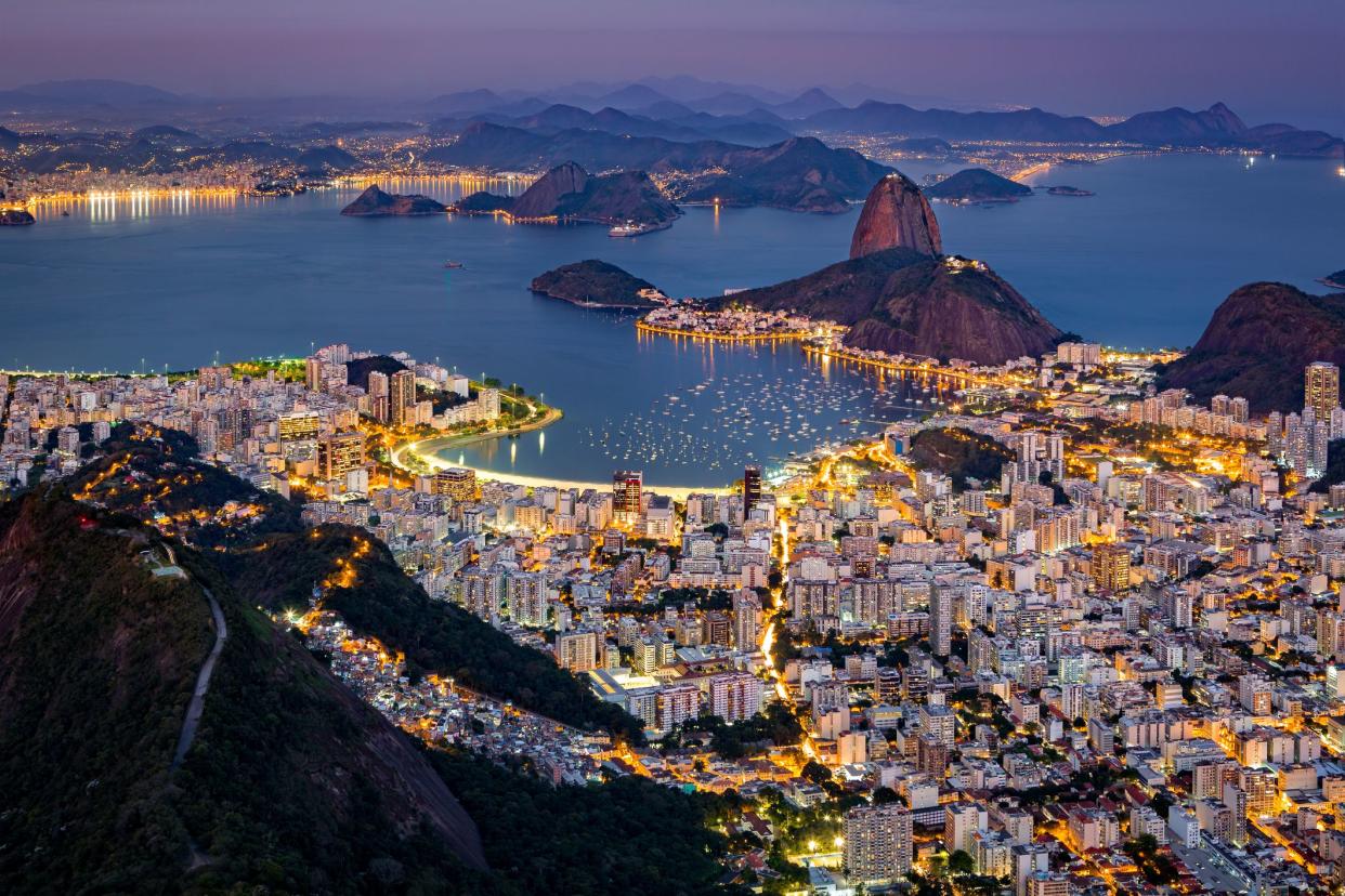 Spectacular aerial view over Rio de Janeiro as viewed from Corcovado. The famous Sugar Loaf mountain sticks out of Guanabara Bay