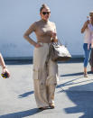 <p> Did I include this outfit because I delight in her pants, with the mismatched cargo pockets at her knees? Partly! Even in head to toe beige, she has to give a little J. Lo energy to it—including a Birkin, of course—and some cozy functional boots. I'm a fan! </p>