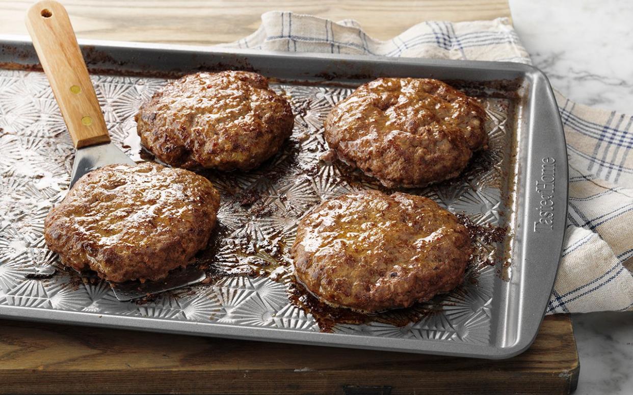 Easy Grilled Hamburgers; How to; marble surface; low camera angle; TOH Baking Pan 13x9; Metal bakeware; oven baked; burgers; hamburgers; hamburger; wood cutting board; wooden cutting board; cutting board; juicy; beef; striped cloth; Step #6 burger patties on ungreased baking sheet; prep; in process