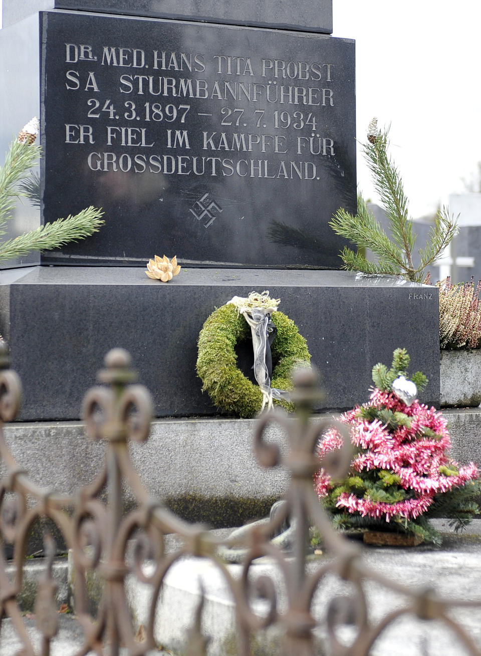 This picture taken Tuesday, Jan. 21, 2014 shows a marble tombstone which is adorned by a swastika and the inscription “He died in the struggle for a Great Germany” at the central cemetery in Graz, Austria. Austrian law bans such symbols, and those displaying them face criminal charges and potential prison terms. Yet the emblems reflecting this country’s darkest chapter in history endure here, and officials here appear either unable or unwilling to do away with them. (AP Photo/Hans Punz)