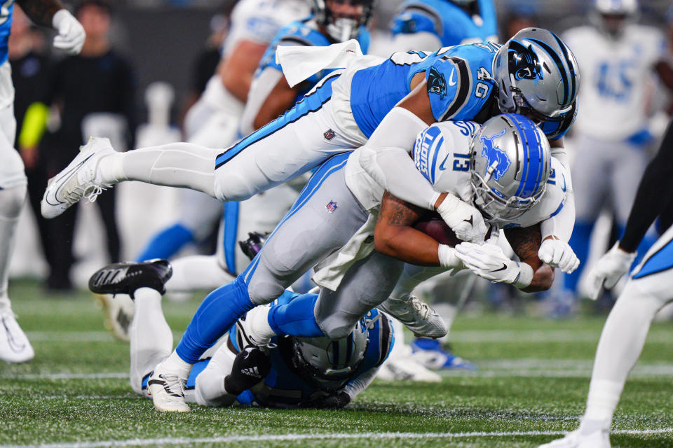 Detroit Lions running back Craig Reynolds is tackled by Carolina Panthers linebacker Eku Leota during the first half of a preseason NFL football game Friday, Aug. 25, 2023, in Charlotte, N.C. (AP Photo/Jacob Kupferman)