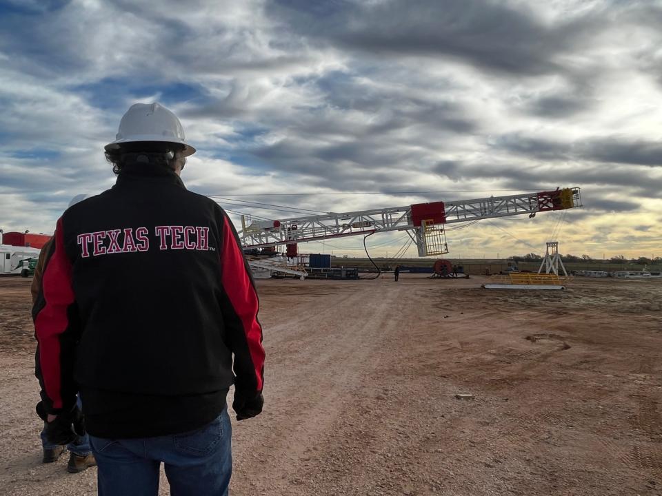 Marshal Watson, chair of the Bob L. Herd Department of Petroleum Engineering at Texas Tech, watched as the 140-foot oil rig mast was raised upright.