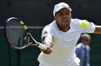 Jo-Wilfried Tsonga of France hits a shot during his match against Ivo Karlovic of Croatia at the Wimbledon Tennis Championships in London, July 4, 2015. REUTERS/Toby Melville -