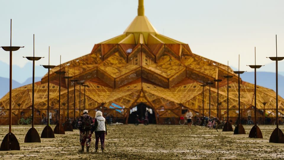 Dawn brought muddy realization to the Burning Man encampment, where the exit gates remain closed indefinitely because driving is virtually impossible. - Trevor Hughes/USA Today