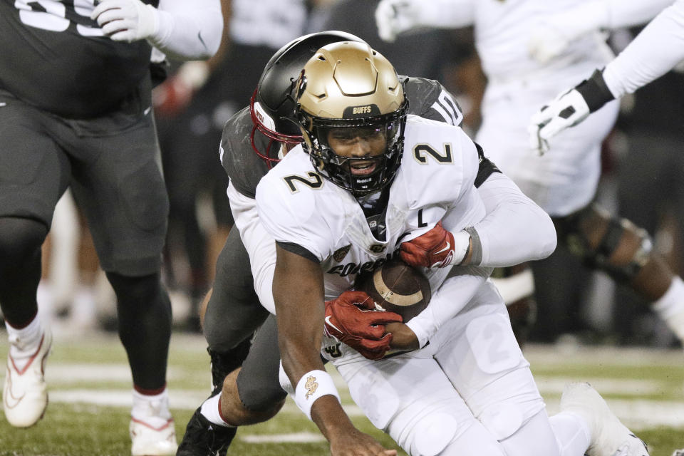 Washington State defensive end Ron Stone Jr. (10) sacks Colorado quarterback Shedeur Sanders (2) during the first half of an NCAA college football game Friday, Nov. 17, 2023, in Pullman, Wash. (AP Photo/Young Kwak)