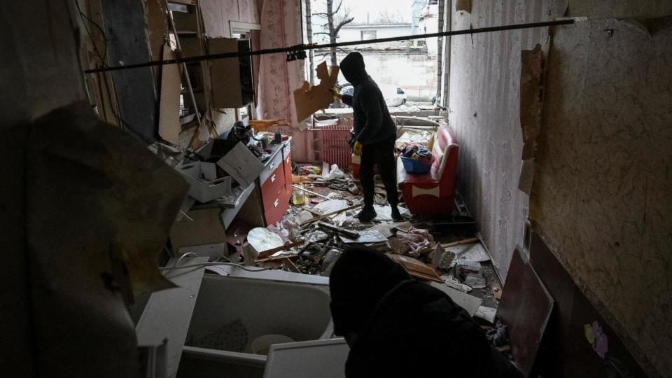 PHOTO: Local residents clean up their apartment in a residential building damaged during a Russian drone strike, amid Russia's attack on Ukraine, in Dnipro, Ukraine Jan. 7, 2024. (Mykola Synelnykov/Reuters)