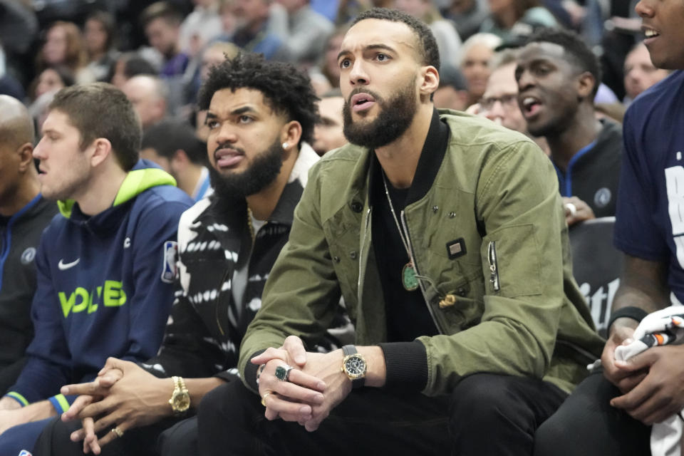 Minnesota Timberwolves' center Karl-Anthony Towns, left, and center Rudy Gobert, right, sit on the bench during the first half of an NBA basketball game against the Utah Jazz Wednesday, Feb. 8, 2023, in Salt Lake City. (AP Photo/Rick Bowmer)