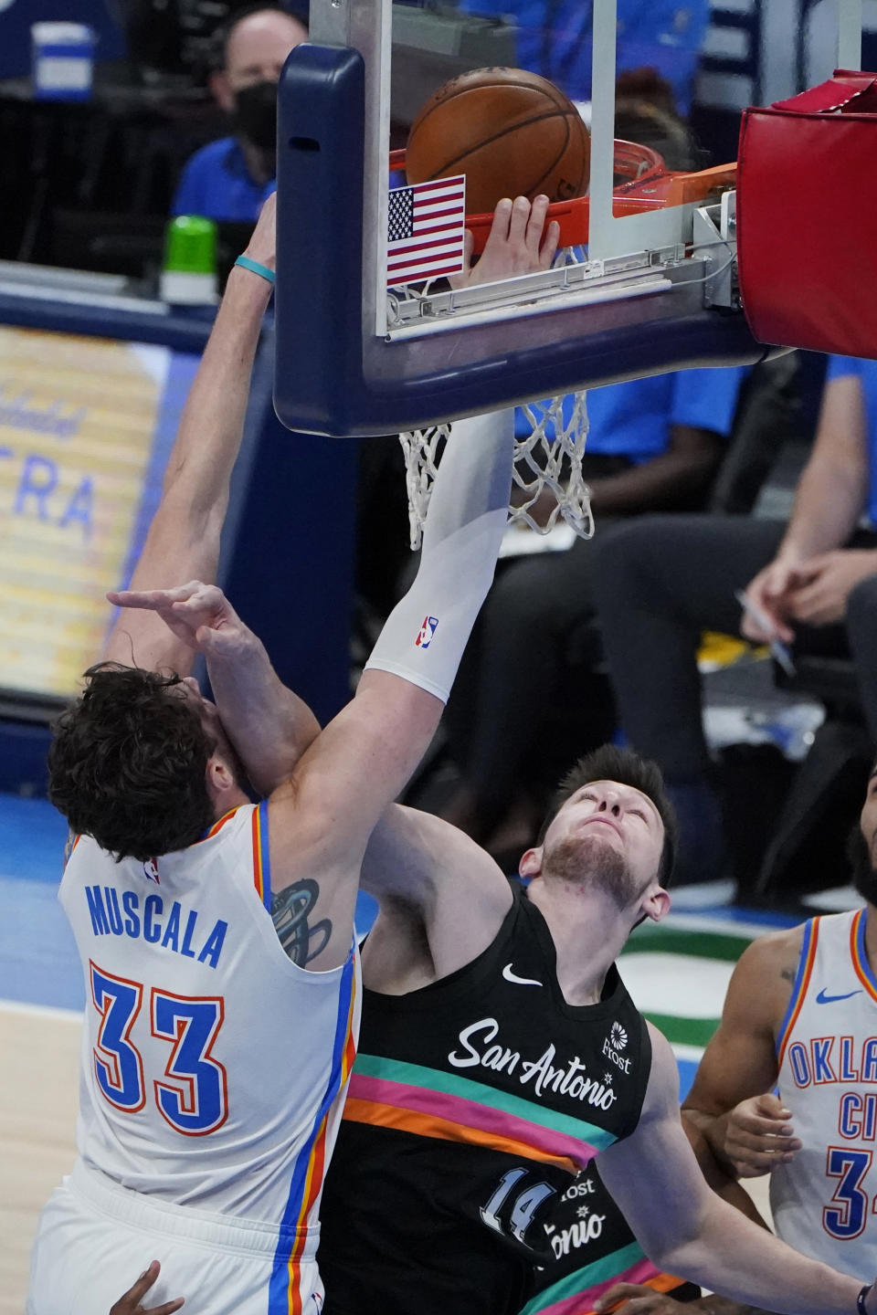 Oklahoma City Thunder center Mike Muscala (33) dunks over San Antonio Spurs forward Drew Eubanks (14) during the second half of an NBA basketball game Wednesday, Feb. 24, 2021, in Oklahoma City. (AP Photo/Sue Ogrocki)