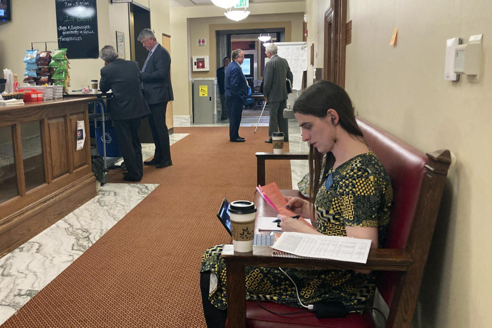 CORRECTS FIRST NAME TO MATT, NOT MARK REGIER - State Rep. Zooey Zephyr sits in a couch in a hallway just outside the main chamber of the House, Thursday, April 27, 2023 in Helena, Mont House Speaker Matt Regier told Zephyr she was not allowed to work in the area. Zephyr was barred from participating on the House floor as Republican leaders voted Wednesday to silence her for the rest of 2023 session after she protested GOP leaders' decision earlier in the week to silence her. (AP Photo/Brittany Peterson)