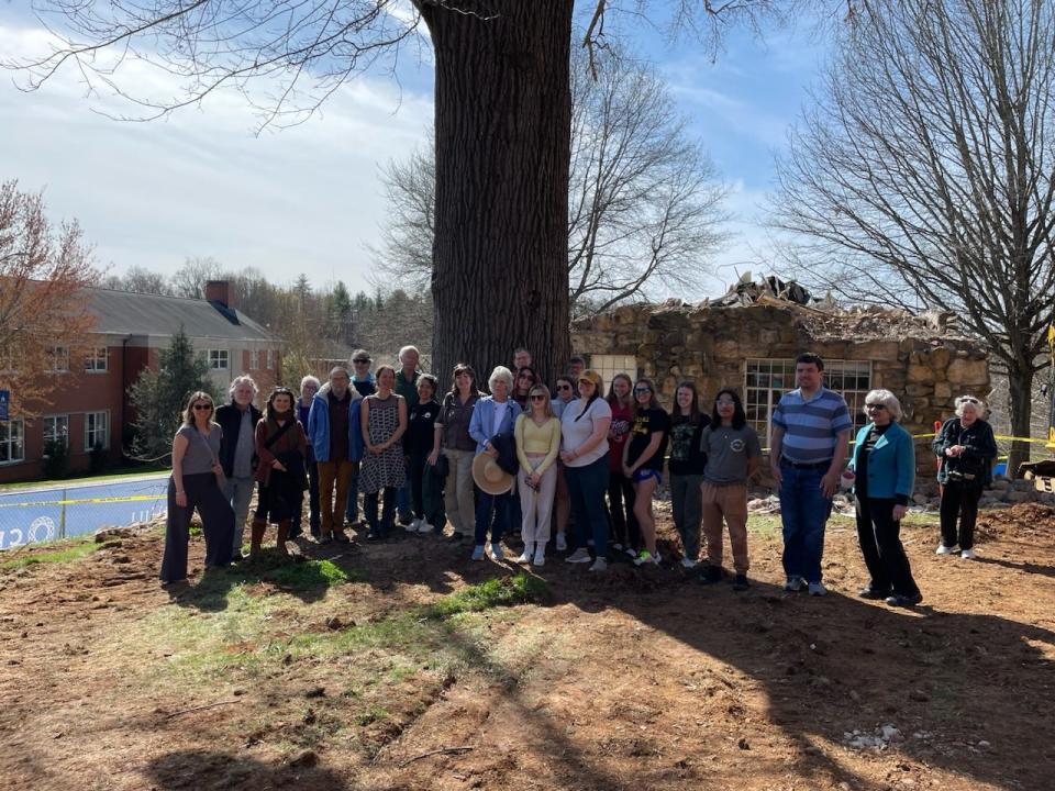 A group of residents stand in front of the Grandmother Oak on Mars Hill University campus March 24. The tree is estimated to be more than 120 years old, and the university administration plans to cut it down ahead of construction of a new student center.
