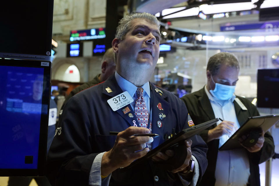 Trader John Panin, left, works on the floor of the New York Stock Exchange, Friday, July 16, 2021. Stocks edged lower Friday, dragged down by a slide from technology companies, as investors digest another round of corporate earnings. (AP Photo/Richard Drew)