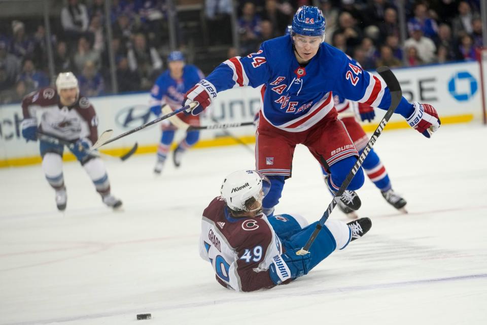 New York Rangers right wing Kaapo Kakko (24) goes over Colorado Avalanche defenseman Samuel Girard (49) during the second period of an NHL hockey game, Monday, Feb. 5, 2024, at Madison Square Garden in New York.