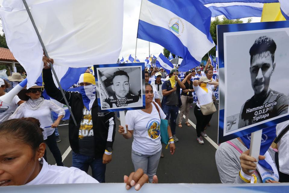 Anti-government demonstrator hold banners of people killed in clashes with police in the past months, during a march supporting the Catholic church, in Managua, Nicaragua, Saturday, July 28, 2018. At least 448 people have been killed, most of them protesters, since the protests began in April. Demonstrators were initially upset over proposed social security cuts but are now demanding President Daniel Ortega leave office after a deadly crackdown by security forces and armed pro-government civilians. (AP Photo/Alfredo Zuniga)