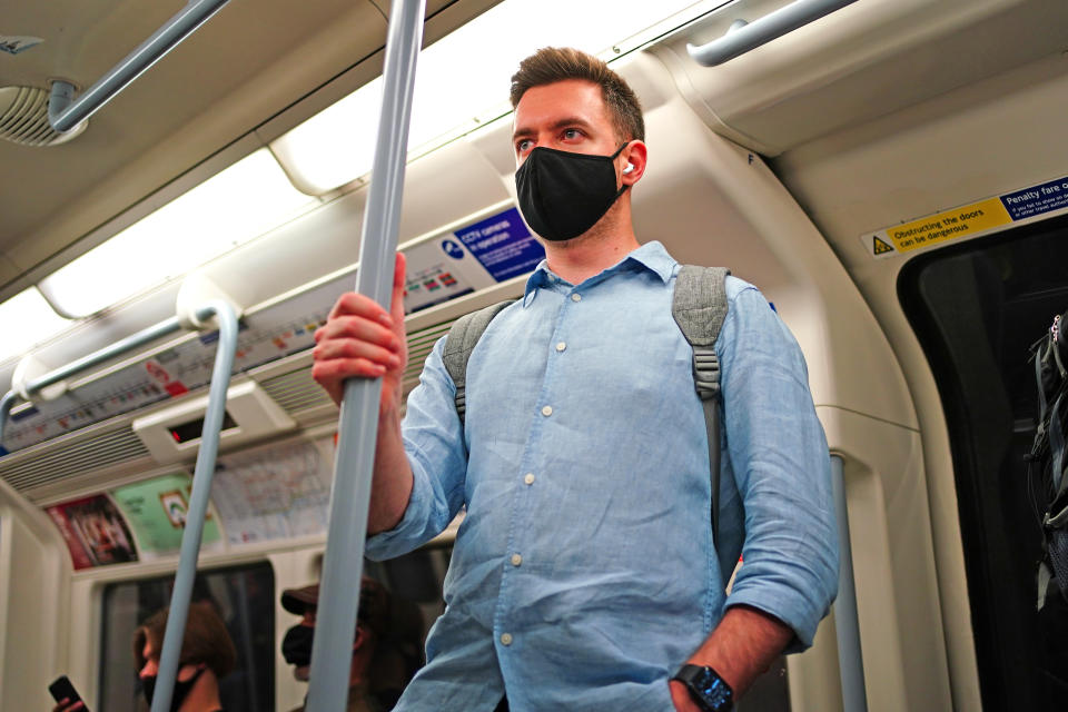 A man wearing a facemask on an underground tube train in central London, during the easing of lockdown restrictions in England. Picture date: Sunday July 4, 2021.