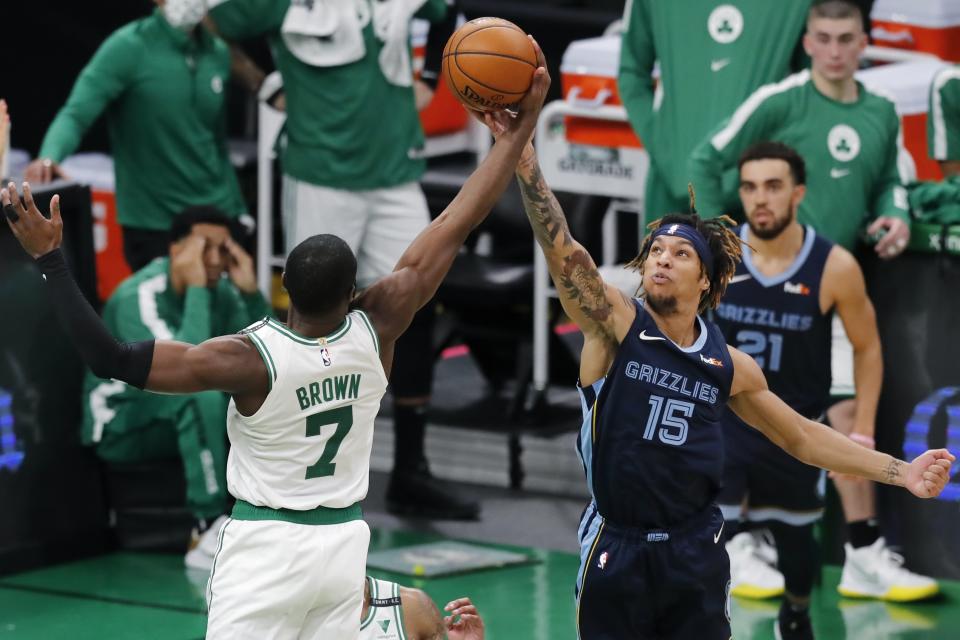 Boston Celtics' Jaylen Brown (7) and Memphis Grizzlies' Brandon Clarke (15) battle for a rebound during the first half of an NBA basketball game, Wednesday, Dec. 30, 2020, in Boston. (AP Photo/Michael Dwyer)