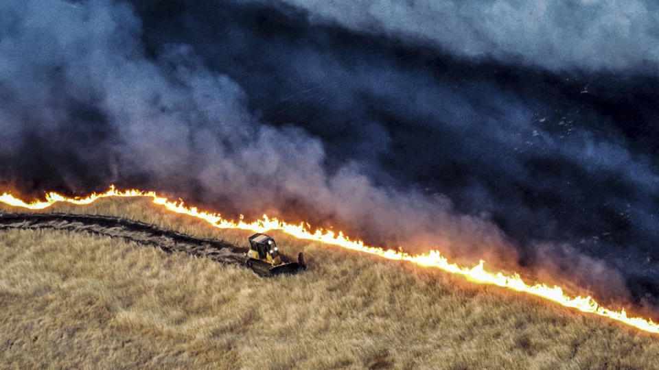 This photo released by the California Department of Forestry and Fire Protection shows a bulldozer working against the Corral Fire on Sunday, June 2, 2024, near Tracy.  / Credit: California Department of Forestry and Fire Protection via AP