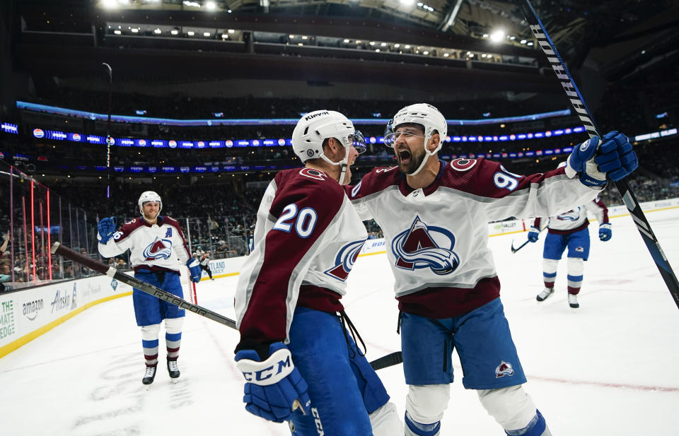 Colorado Avalanche center Ross Colton (20) celebrates scoring a goal against the Seattle Kraken with teammate Tomas Tatar (90) during the second period of an NHL hockey game, Monday, Nov. 13, 2023, in Seattle. (AP Photo/Lindsey Wasson)