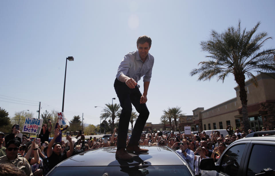 Democratic presidential candidate and former Texas congressman Beto O'Rourke speaks from the roof of his car to an overflow crowd at a campaign stop at a coffee shop Sunday, March 24, 2019, in Las Vegas. (AP Photo/John Locher)