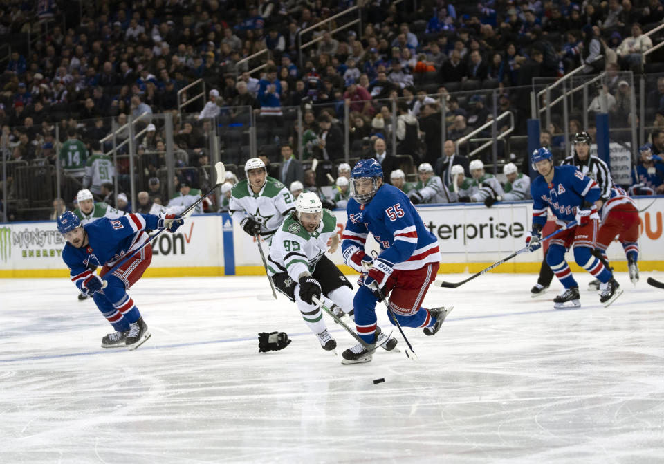 New York Rangers defenseman Ryan Lindgren (55) and Dallas Stars center Matt Duchene (95) fight for the puck during the first period of an NHL hockey game on Tuesday, Feb. 20, 2024 in New York. (AP Photo/Peter K. Afriyie)