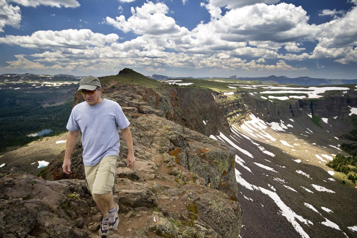 senior man hiking in the mountains in Colorado