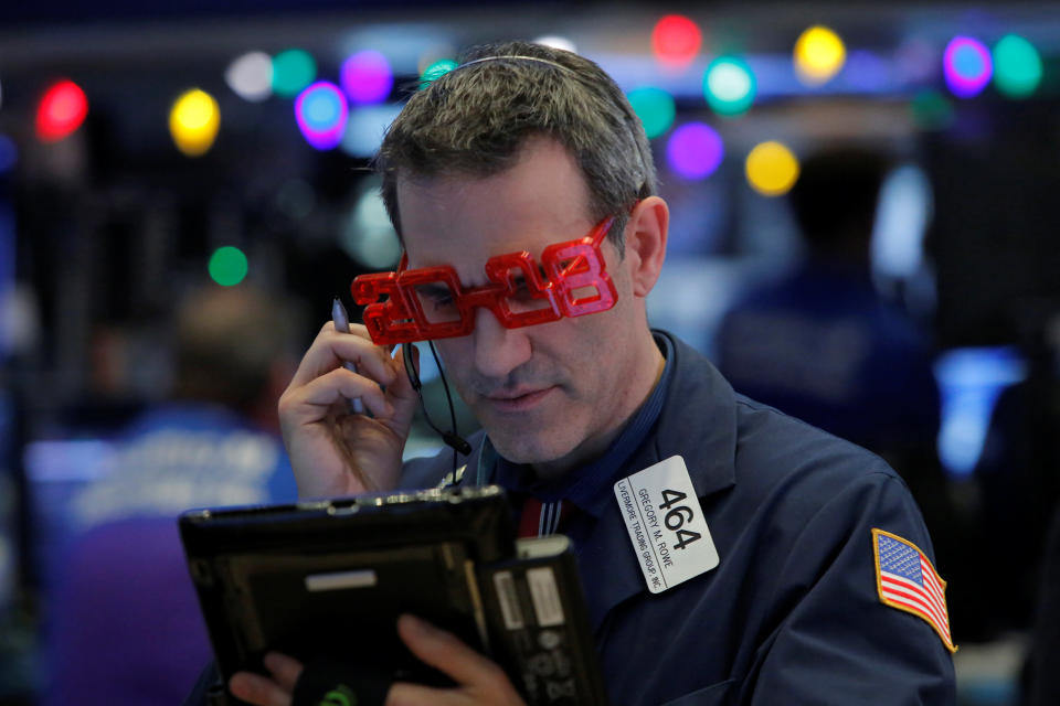 Trader Gregory Rowe works on the trading floor as the final day of trading for the year draws to a close with the Dow Jones Industrial Average setting a record high close for a trading year at the New York Stock Exchange (NYSE) in Manhattan, New York, U.S., December 29, 2017. REUTERS/Andrew Kelly