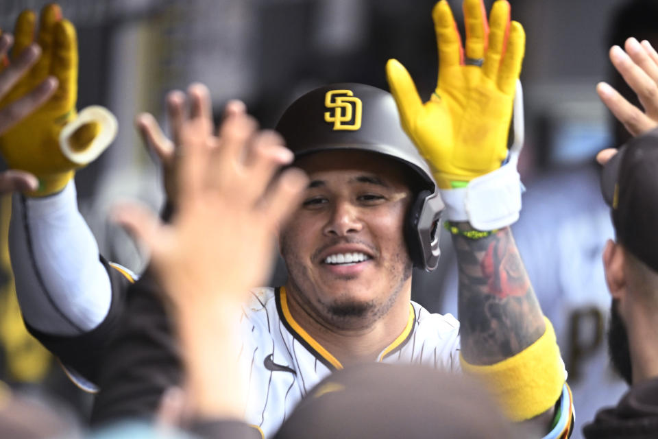 San Diego Padres' Manny Machado is congratulated after hitting a solo home run against the Cleveland Guardians during the third inning of a baseball game Wednesday, June 14, 2023, in San Diego. (AP Photo/Denis Poroy)