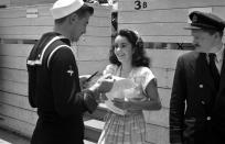 <p>When the actress was only 13 years old she was already hugely famous thanks to her roles in films like <em>Lassie Comes Home </em>and <em>National Velvet</em>. Here she's seen being stopped for an autograph by a sailor. </p>