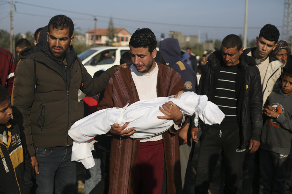 Palestinian Abdul Rahman Sharif holds the body of his four-year-old son Abdul Rahman Muamm, killed in the Israeli bombardment of the Gaza Strip, during his funeral in Khan Younis, Monday, Feb. 26, 2024. (AP Photo/Hatem Ali)