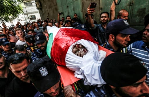Security forces loyal to Palestinian Islamist movement Hamas carry away the body of comrade Salama al-Nadeem, 32, during his funeral in Gaza City