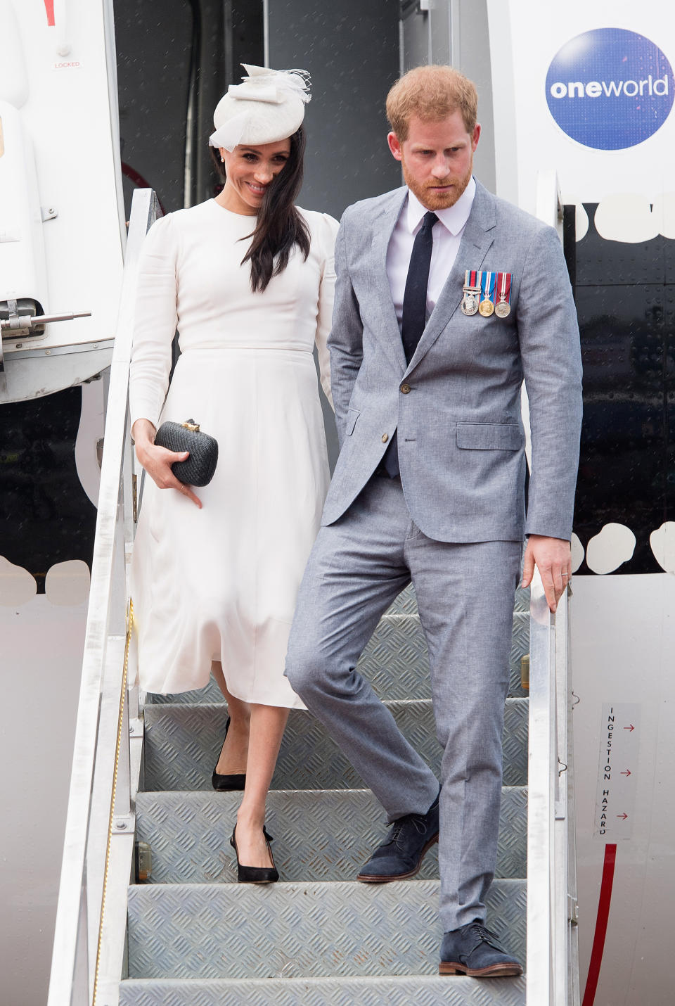 <p>The Duchess of Sussex touched down at Nausori Airport on October 23 in a bespoke cream-hued dress by Aussie label Zimmerman with a co-ordinating hat by Stephen Jones. But it was her jewellery that hit headlines: The Duchess paired earrings from the Queen with a bracelet from Prince Charles. <em>[Photo: Getty]</em> </p>