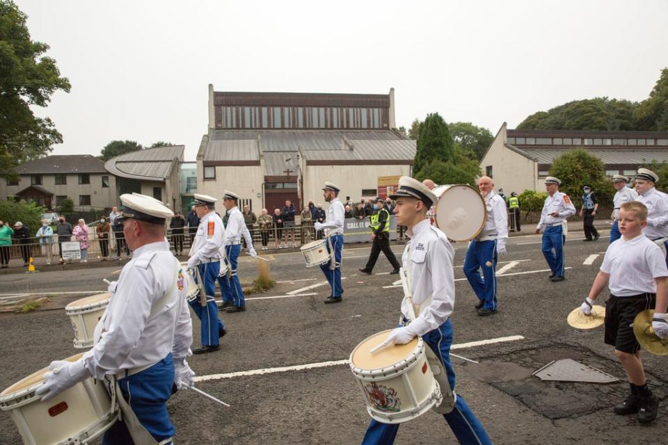 A silent Orange Order band passes by (Robert Perry/PA) (PA Wire)