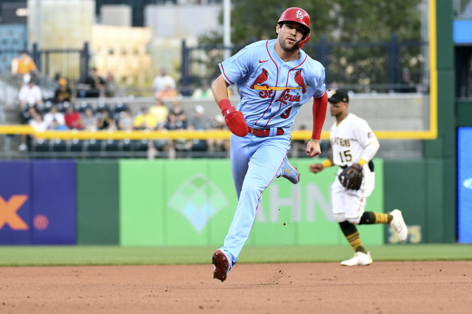 St. Louis Cardinals' Dylan Carlson, foreground, passes Pittsburgh Pirates second baseman Wilmer Difo (15) on his way to scoring in the second inning of a baseball game Saturday, Aug. 28, 2021, in Pittsburgh, Pa. (AP Photo/Philip G. Pavely)