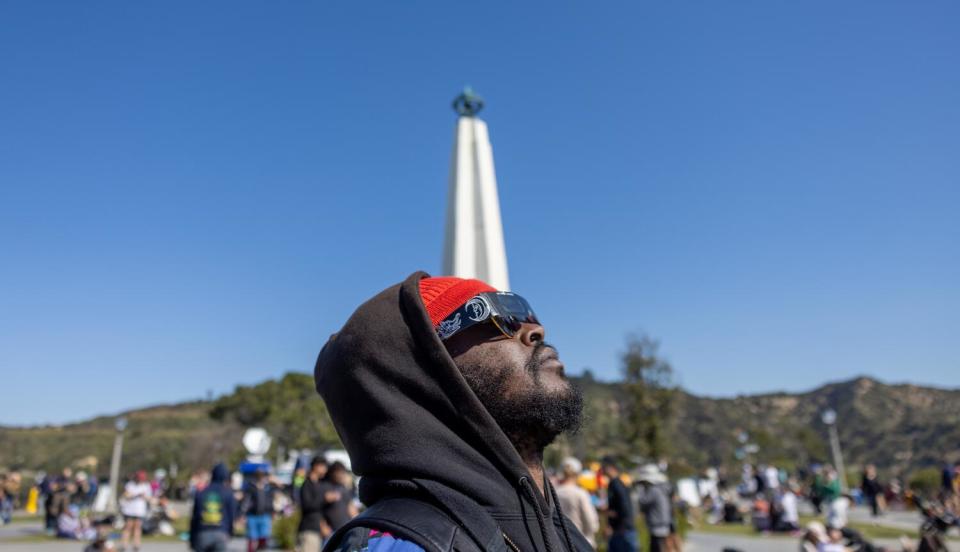 Duke Brobby watches the solar eclipse outside Griffith Observatory.