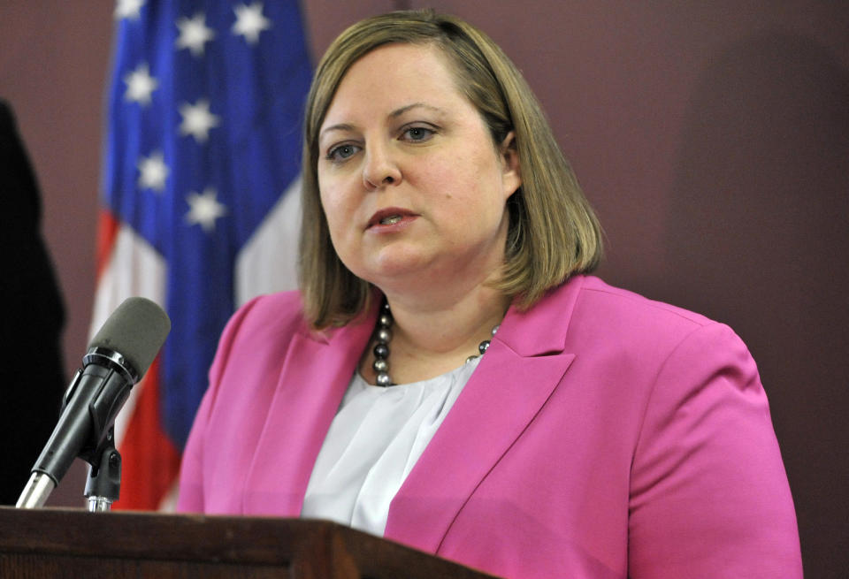 FILE - In this April 29, 2014, file photo, Erin Deveney, interim head of the Massachusetts Department of Children and Families, speaks during a news conference in Boston. Volodymyr Zhukovskyy, a driver for a transport company who has a history of traffic arrests, pleaded not guilty Tuesday, June 25, 2019, to seven counts of negligent homicide in a collision with a group of motorcyclists on a rural highway. His case also led late Tuesday to the resignation of Deveney, the head of the motor vehicle division in Massachusetts, after it was determined Zhukovskyy's commercial driving license should have been suspended following a drunk driving arrest in Connecticut in May. (AP Photo/Josh Reynolds, File)