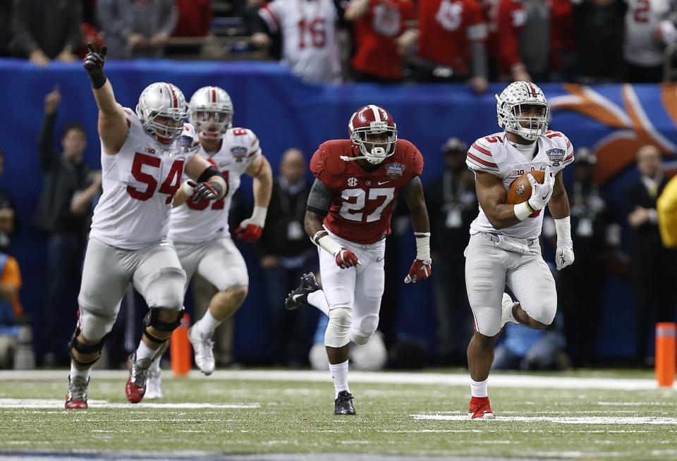 Ohio State Buckeyes running back Ezekiel Elliott (15) breaks away for long touchdown run in the fourth quarter of the Allstate Sugar Bowl and College Football Playoff Semifinal at Mercedes-Benz Superdome in New Orleans, Friday night, January 2, 2015. The Ohio State Buckeyes defeated the Alabama Crimson Tide 42 - 35. (The Columbus Dispatch / Eamon Queeney) 