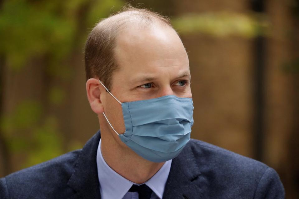 Britain's Prince William, Duke of Cambridge wears a face mask as he visits St. Bartholomew's Hospital in London, to mark the launch of the nationwide 'Hold Still' community photography project on October 20, 2020.