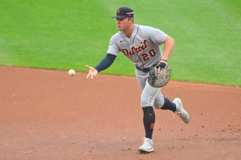 Detroit Tigers first baseman Spencer Torkelson (20) tosses the ball to first base in the first inning against the Cleveland Guardians at Progressive Field.