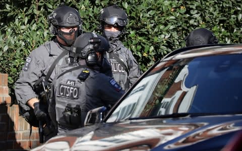 Armed policemen stand outside Parsons Green - Credit: KEVIN COOMBS/Reuters