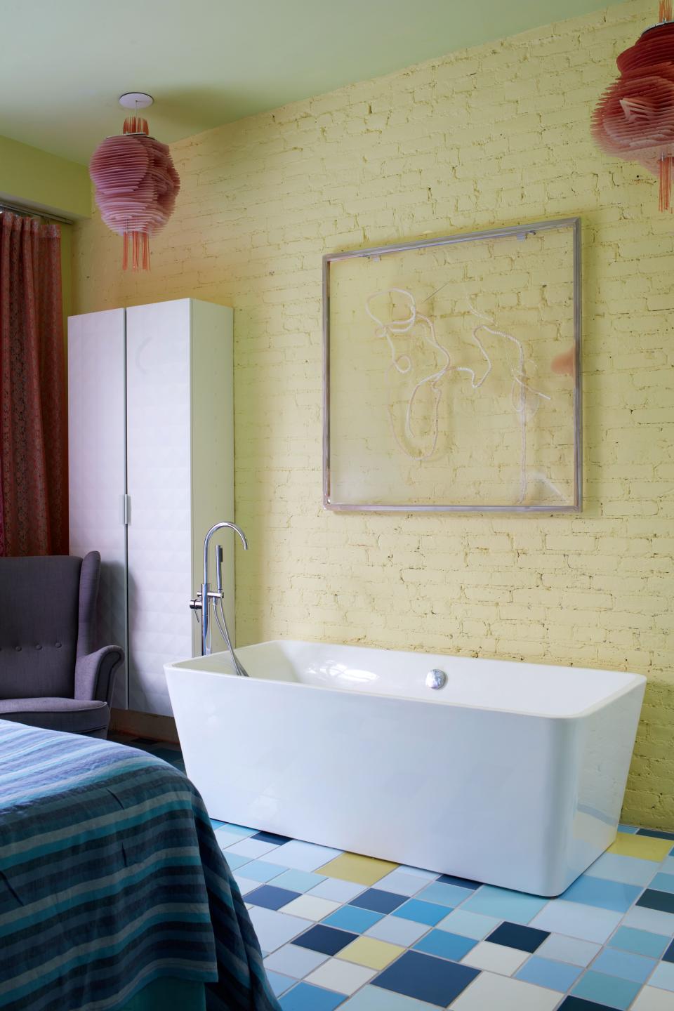 A Seth Price artwork hangs above the tub in Pardo’s bedroom.