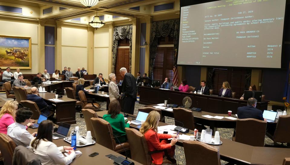 Sen. Julie Daniels and Sen. Dave Radar confer Tuesday at a Senate Education Committee meeting.