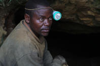 In this photo taken Aug. 17, 2012 photo, a man who used to earn a living mining cassiterite, the major ore of tin, poses for a portrait at the entrance to a mine shaft, at the largely-abandoned Nyabibwe mine, in eastern Congo. Gold is now the primary source of income for armed groups in eastern Congo, and is ending up in jewelry stores across the world, according to a report published Thursday, Oct. 25, 2012, by the Enough Project. Following American legislation requiring companies to track the origin of the minerals they use, armed groups have been unable to profit from the exploitation of tin, tungsten, and tantalum, and have turned instead to gold, which is easier to smuggle across borders. Gold miners, like cassiterite miners, work in extreme conditions, with crude equipment such as pick-axes and shovels. (AP Photo/Marc Hofer)