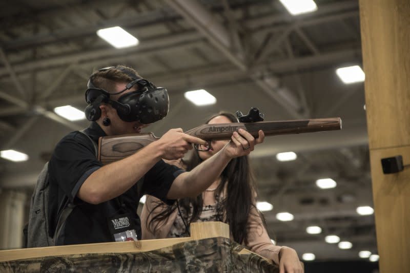 A convention attendee inspects a gun on the floor of the exhibition hall at the 147th National Rifle Association Annual Meetings and Exhibits at the Kay Bailey Hutchison Convention Center in Dallas on May 5, 2018. The NRA was founded November 17, 1871. File Photo by Sergio Flores/UPI