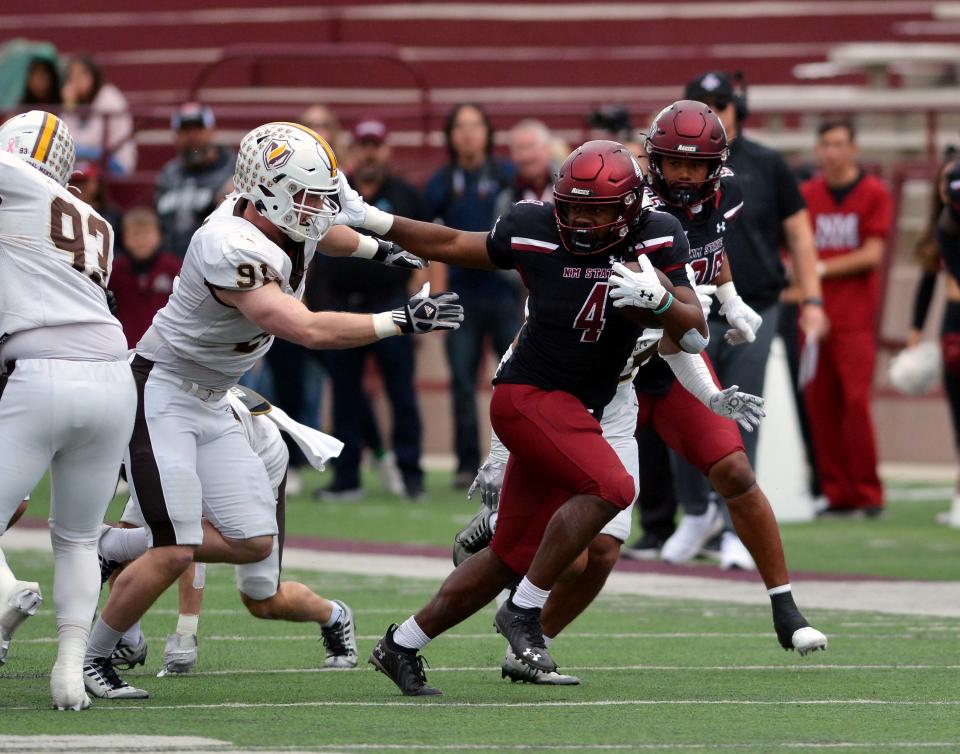 Aggie Running Back Star Thomas (4) gets by a Valparaiso defender by using a stiff arm on Saturday afternoon.