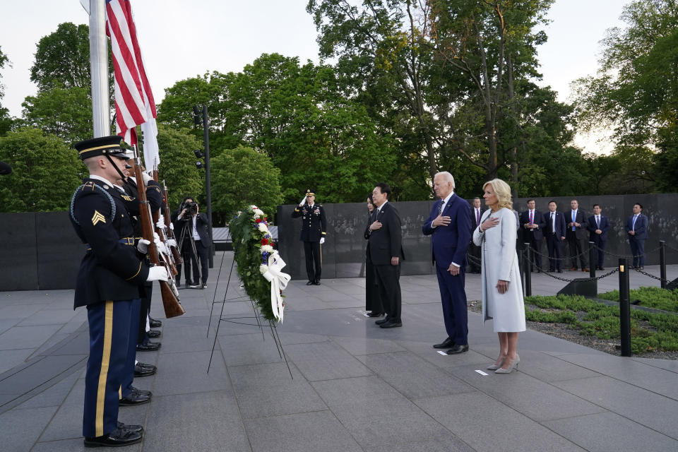 President Joe Biden, first lady Jill Biden, South Korea's President Yoon Suk Yeol and his wife Kim Keon Hee pause as they lay a wreath as they visit the Korean War Veterans Memorial in Washington, Tuesday, April 25, 2023. (AP Photo/Susan Walsh)