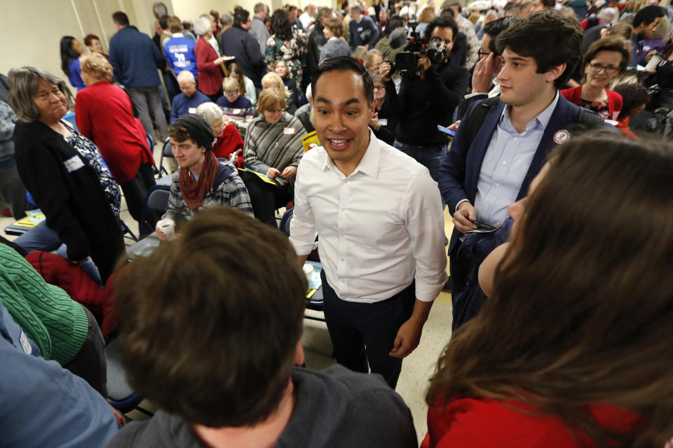 Former Housing and Urban Development Secretary and 2020 Democratic presidential hopeful Julian Castro, center, speaks to local residents at the Story County Democrats' annual soup supper fundraiser, Saturday, Feb. 23, 2019, in Ames, Iowa. (AP Photo/Charlie Neibergall)