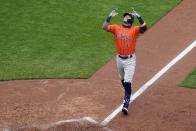 Houston Astros' Carlos Correa celebrates his go-ahead solo home run off Minnesota Twins relief pitcher Cody Stashak in the seventh inning in Game 2 to clinch the American League wild-card baseball series, Wednesday, Sept. 30, 2020, in Minneapolis. The Astros won 3-1 to win the three-game series. (AP Photo/Jim Mone)