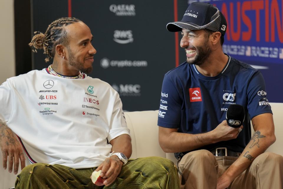 Mercedes driver Lewis Hamilton, left, of Britain, talks with AlphaTauri driver Daniel Ricciardo, of Australia, during a news conference before the Formula One U.S. Grand Prix auto race at Circuit of the Americas, Friday, Oct. 20, 2023, in Austin, Texas. (AP Photo/Nick Didlick)