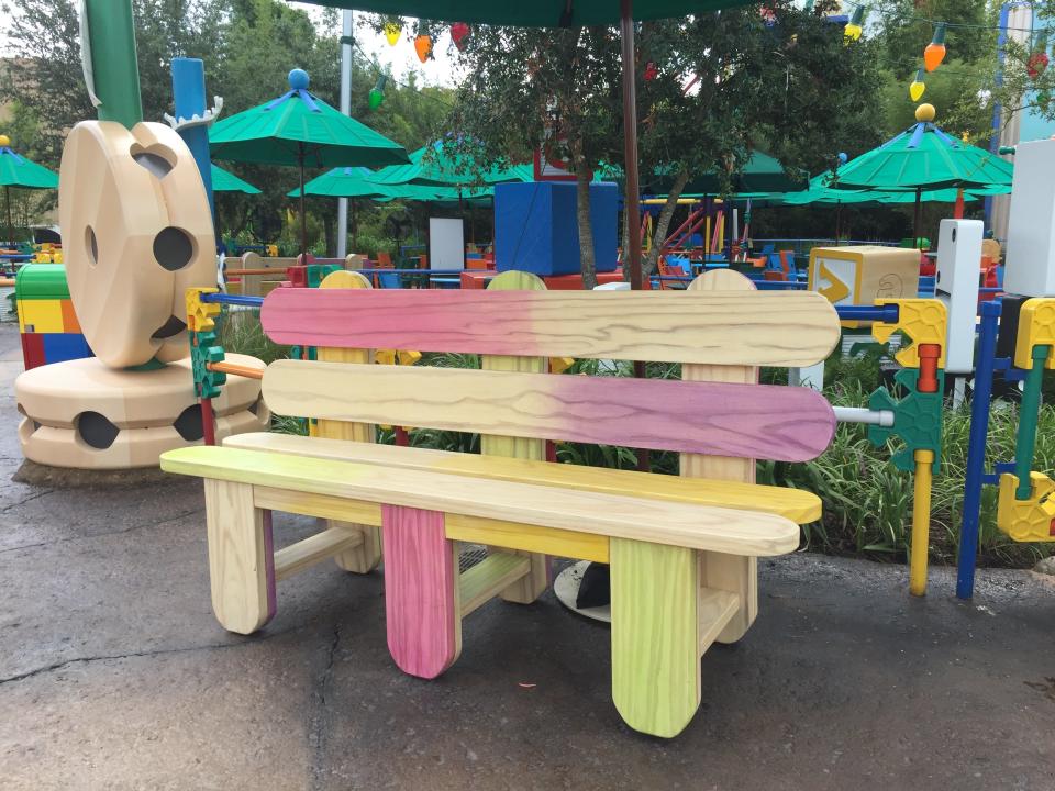 Benches made of popsicle sticks give Toy Story Land a whimsical touch.