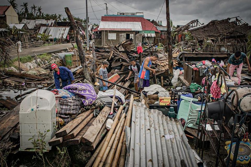 Residents try to salvage belongings amongst their houses destroyed at the height of Typhoon Vongfong in San Policarpio town, Eastern Samar province on Friday. Source: Getty