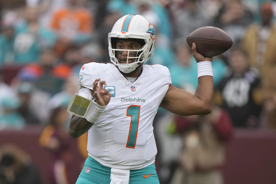 Miami Dolphins quarterback Tua Tagovailoa (1) passes against the Washington Commanders during the first half of an NFL football game Sunday, Dec. 3, 2023, in Landover, Md. (AP Photo/Mark Schiefelbein)